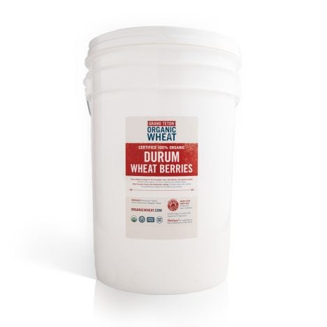 White 6 gallon Super Pail of Grand Teton Organic Durum Wheat Berries with a sealed lid and product label on a white background