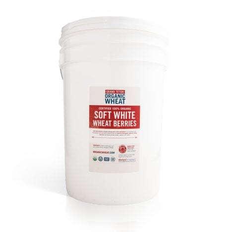 White 6 gallon Super Pail of Grand Teton Organic Soft White Wheat Berries with a sealed lid and product label on a white background